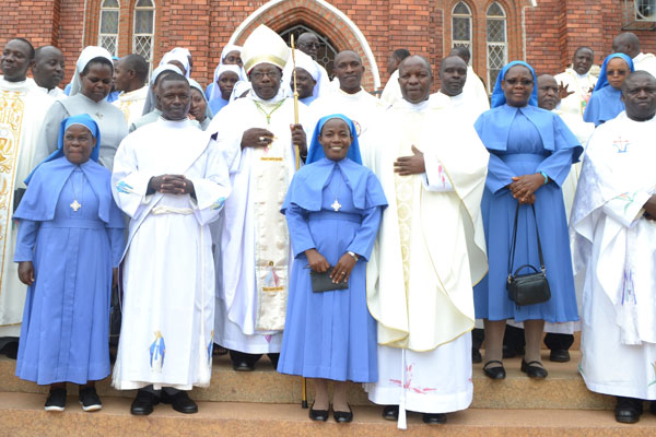 Light moment. Bishop Kaggwa (2nd left) with the bishop-elect, Msgr Serverus Jjumba (2nd right) and other clergy after mass at Kitovu Cathedral on March 24. PHOTO BY GERTRUDE MUTYABA