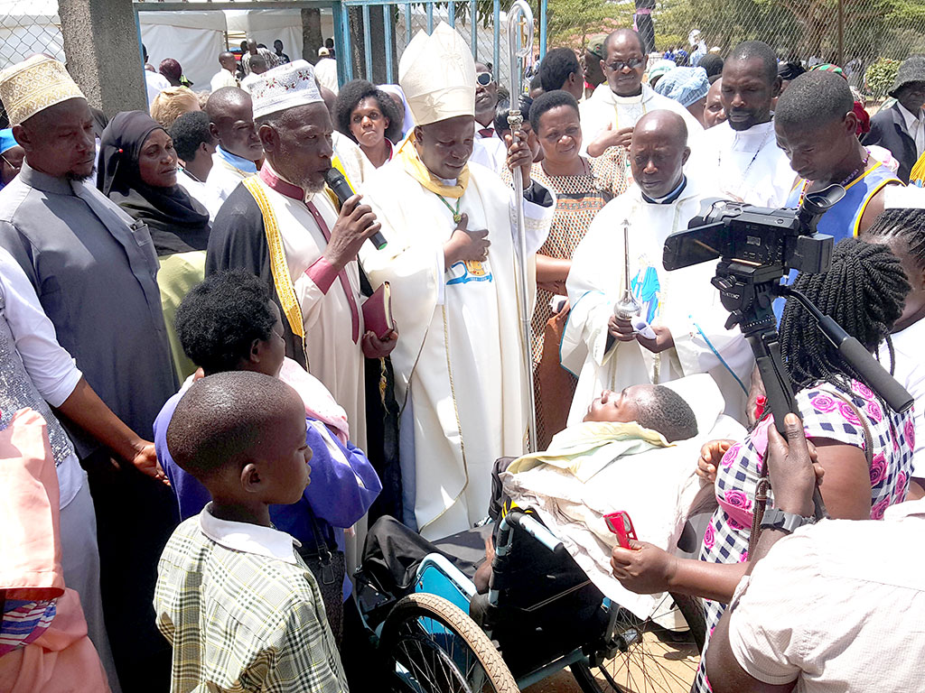 Bishop Serverus Jjumba with Lyantonde District Khadd praying for the sick