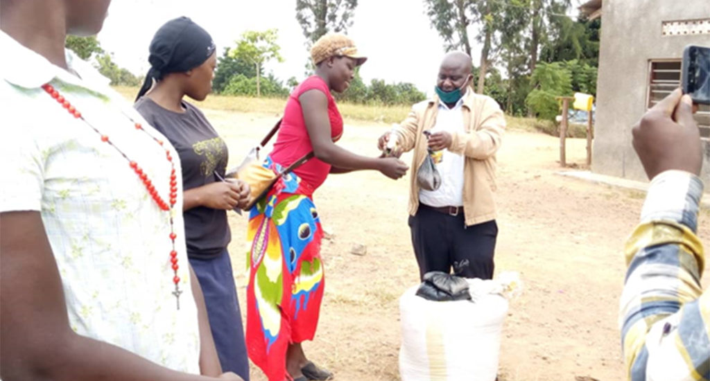 to-AGYW-to-strengthen-their-income-from-Kibinge LC III chairperson Mr. Sowedi handing over IGA input for back yard gardening to AGYW to strengthen their income from Kibinge s/c head quarters on 18/07/2020